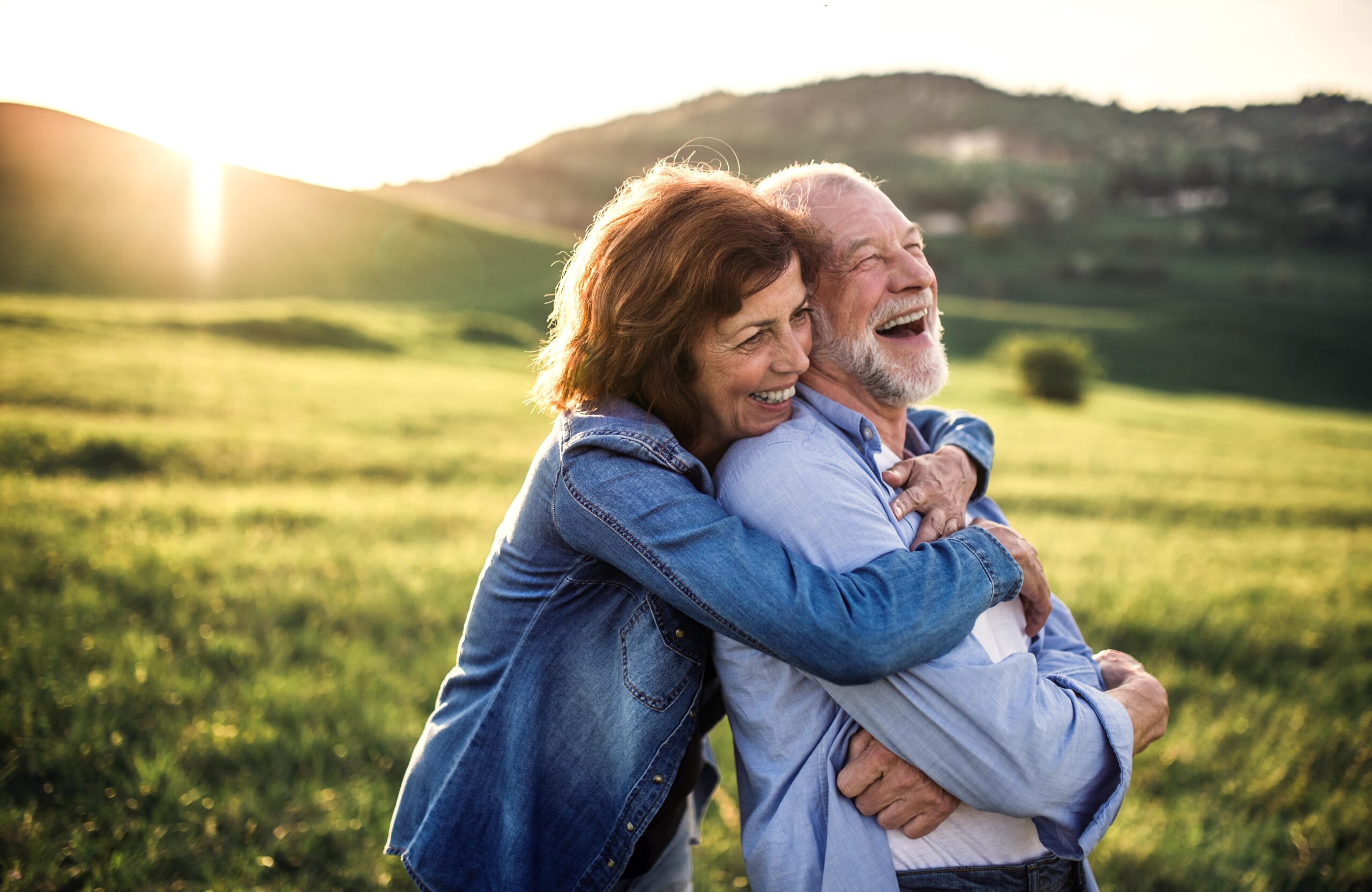 family hugging in a field