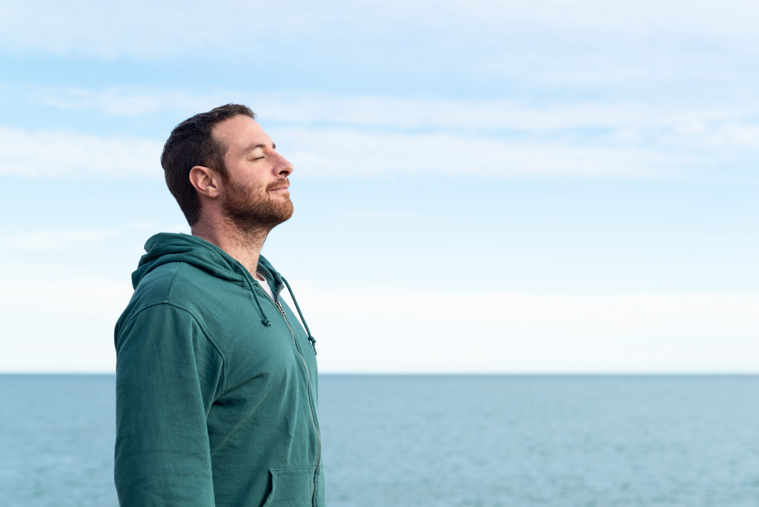 Relaxed man breathing fresh air.