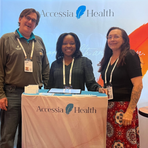 Jennifer Noonan, Tiara Green, and Alan Wood attend a conference