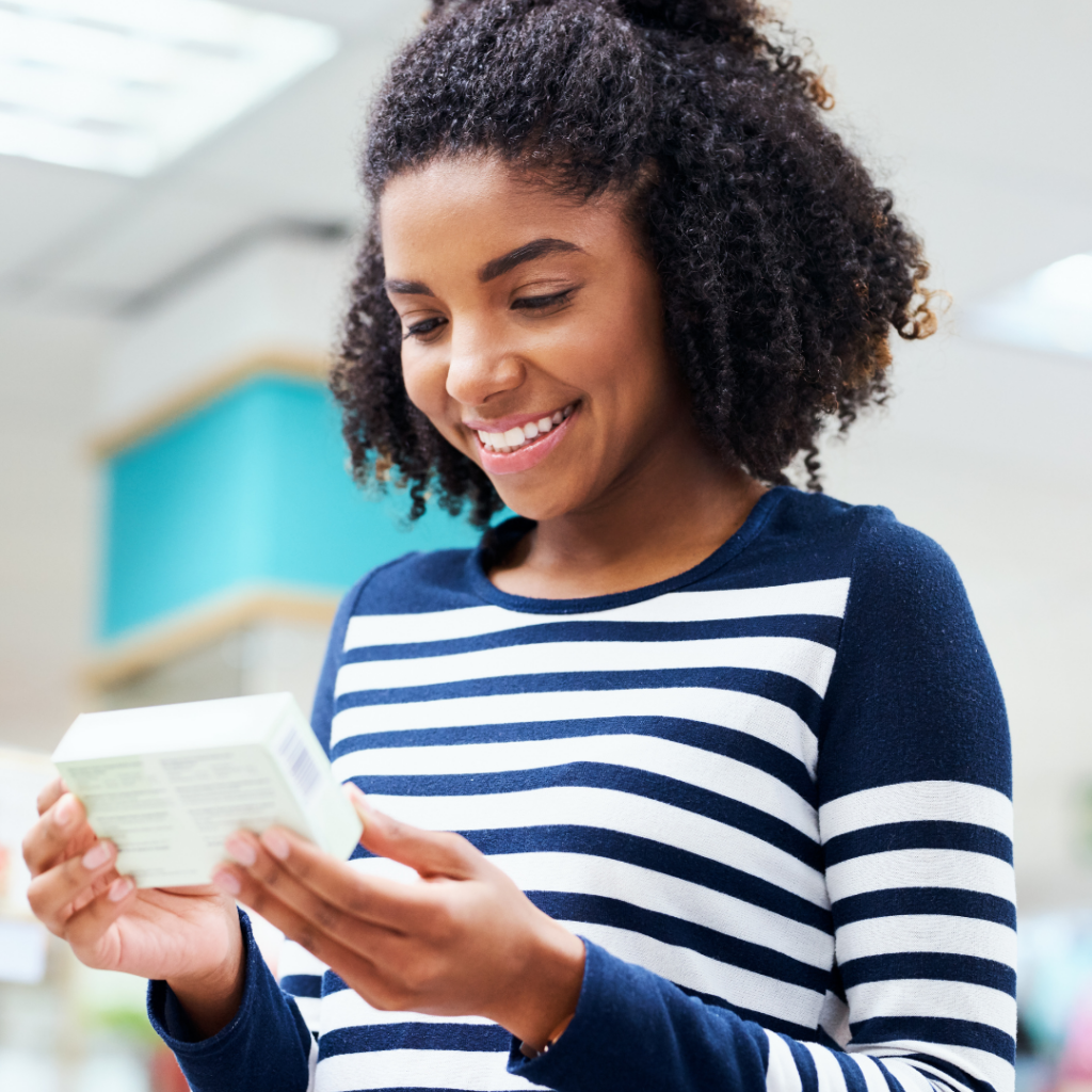 Woman looks down to read her prescription | Rare Disease Financial Resources Beyond Copays