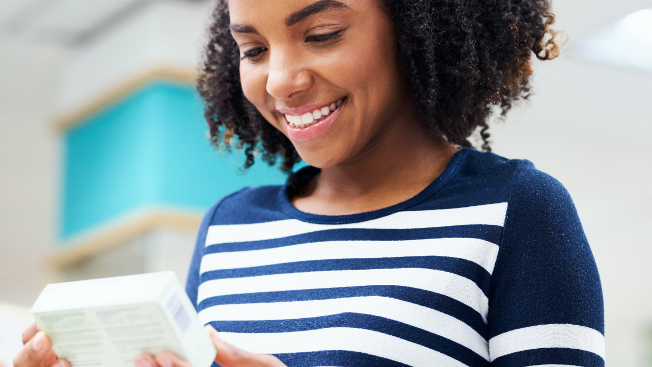 Woman looks down to read her prescription | Rare Disease Financial Resources Beyond Copays