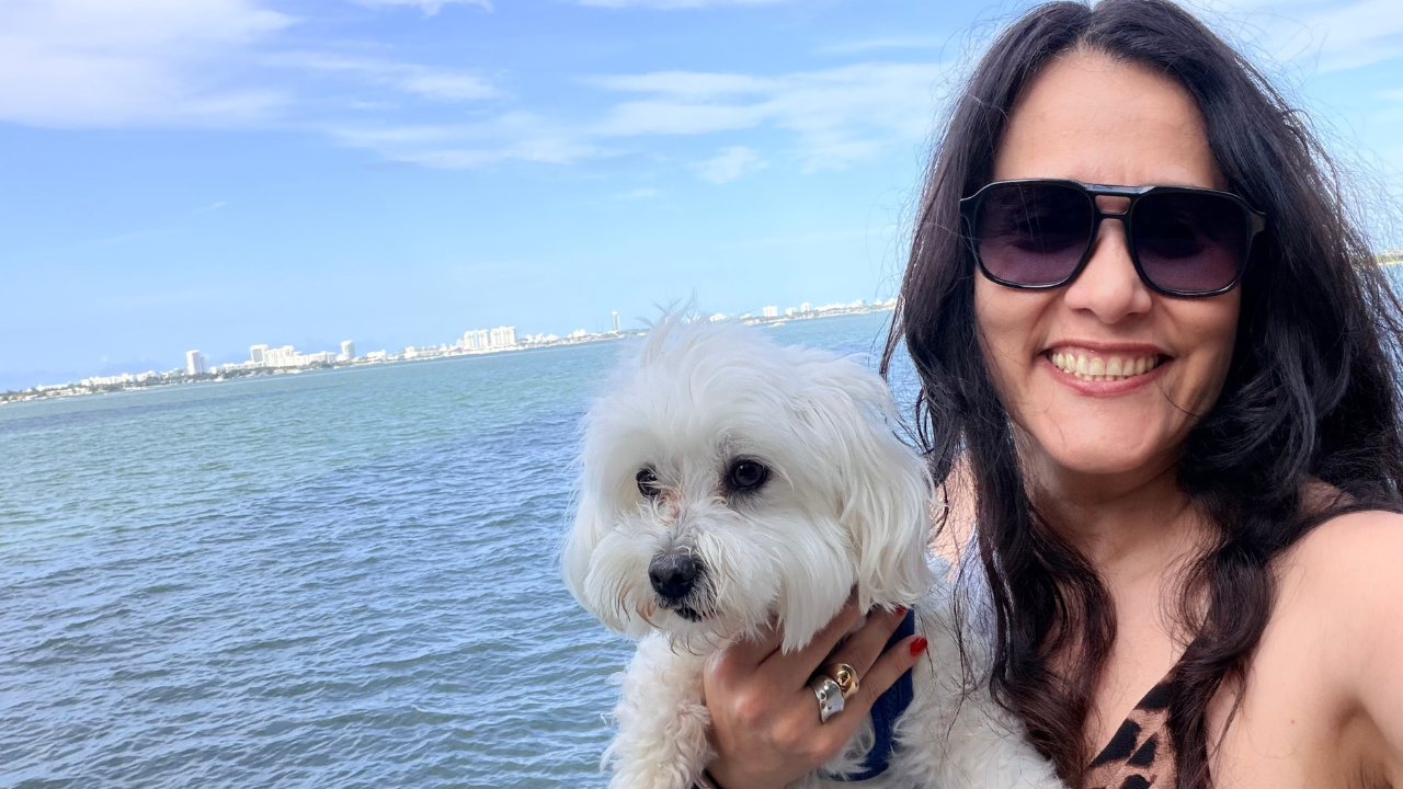 Narah Cano smiles as she holds her dog | Fabry Disease